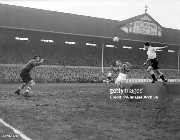 Len Dunquemin, Spurs centre forward, jumps high to head the ball towards the Liverpool goalkeeper Charlie Ashcroft, as Ray Lambert tries to intervene.