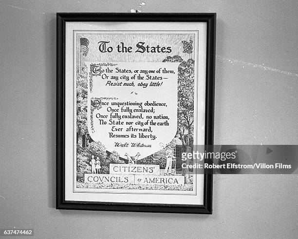 View of a framed poster, from the white supremacist Citizens' Councils of America and quoting Walt Whitman, on a wall in City Hall, Greenwood,...