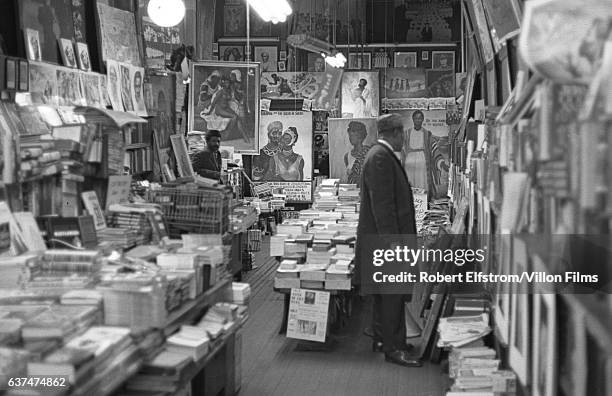 Interior view of the African National Memorial Bookstore in Harlem, New York, New York, 1964. An unidentified man browses the shelves.