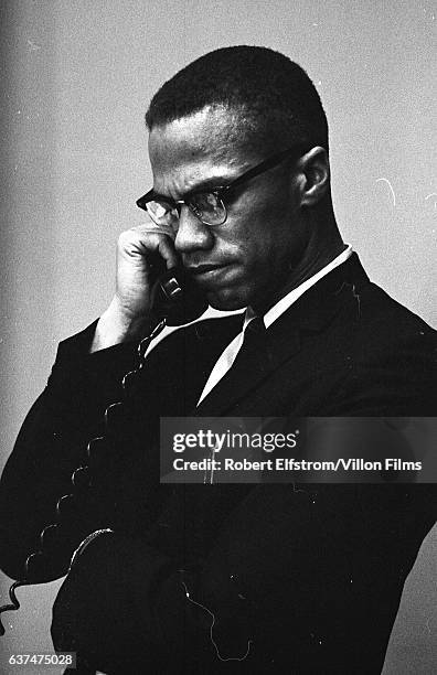 American religious and Civil Rights leader Malcolm X talks on a telephone at the Lenox Hotel, Boston, Massachusetts, 1964.