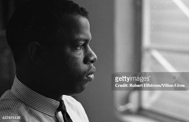Close-up of American Civil Rights activist John Lewis, chairman of the Student Non-Violent Coordinating Committee , in an office, New York, 1964.