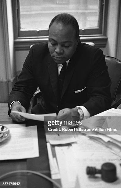 View of American Civil Rights activist James Farmer Jr , co-founder of the Congress of Racial Equality , as he works at a desk in his office, New...