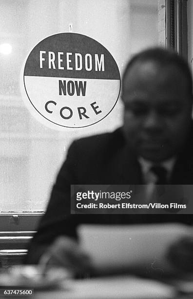 Close-up of American Civil Rights activist James Farmer Jr , co-founder of the Congress of Racial Equality , in his office, New York, 1964.