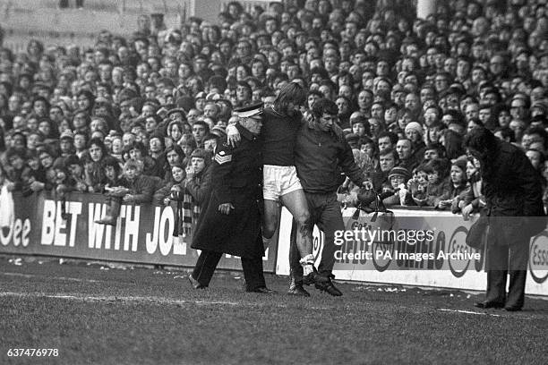 West Ham captain Billy Bonds is carried off the pitch in the opening minutes of the game.