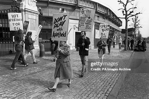 Supporters of the Anti-Apartheid 'Stop the Tour' movement parade with posters outside the Grace Gate at Lord's.