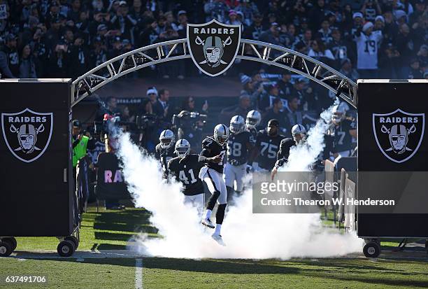 Marquette King and the Oakland Raiders runs onton the field prior to playing the Indianapolis Colts in an NFL football game at the Oakland-Alameda...