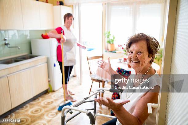 caregiver doing the chores - clean home stock pictures, royalty-free photos & images