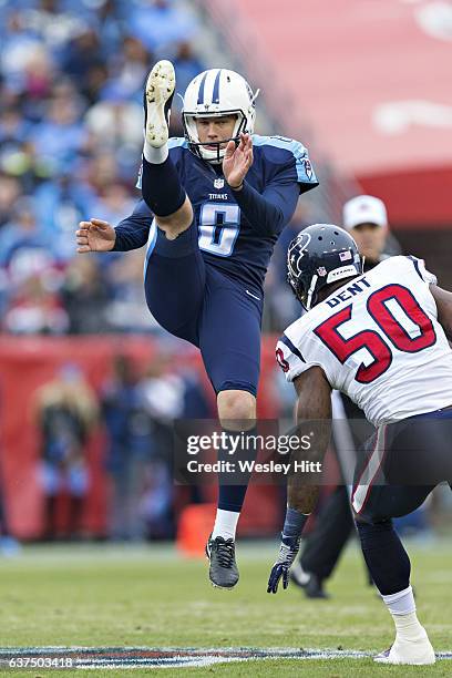 Brett Kern of the Tennessee Titans punts the ball under pressure from Akeem Dent of the Houston Texans at Nissan Stadium on January 1, 2017 in...