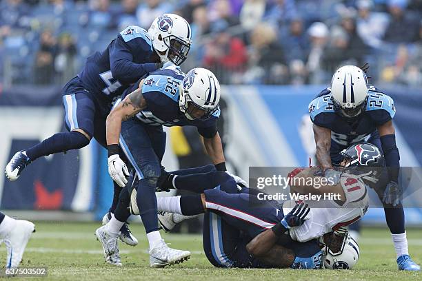 Daimion Stafford and Avery Williamson of the Tennessee Titans tackle Jonathan Grimes of the Houston Texans at Nissan Stadium on January 1, 2017 in...