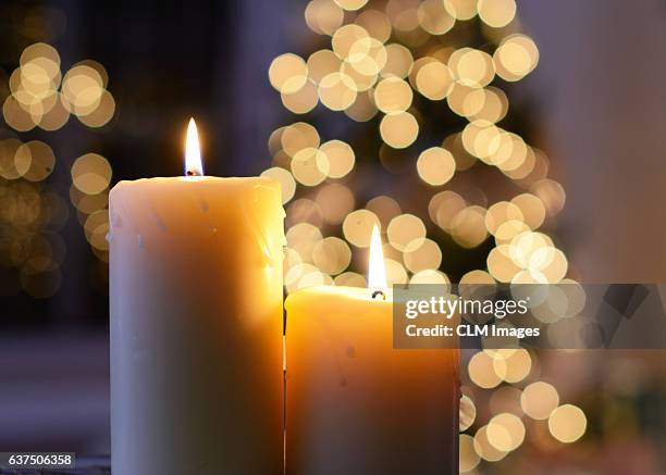 candles and christmas lights - christmas candle stock pictures, royalty-free photos & images