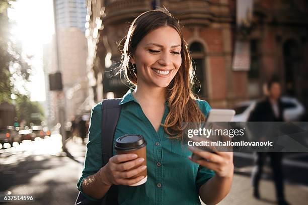using smartphone while crossing street - sydney morning stock pictures, royalty-free photos & images