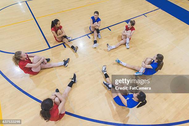 high school female volleyball players warming up together - warm up exercise stock pictures, royalty-free photos & images