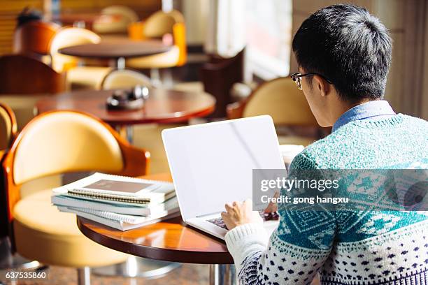 young asian man student using laptop - university asian students international portrait stock pictures, royalty-free photos & images