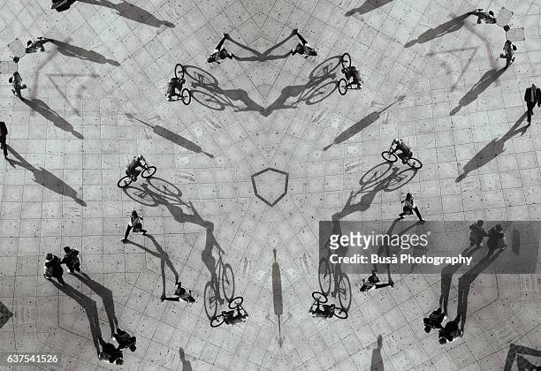 abstract image: kaleidoscopic rendering of aerial image of pedestrians walking in the city - rock formation light stock pictures, royalty-free photos & images
