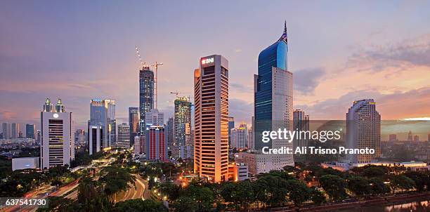 sunset over jakarta skyline, capital city of indonesia. jakarta, indonesia. - jakarta stock-fotos und bilder