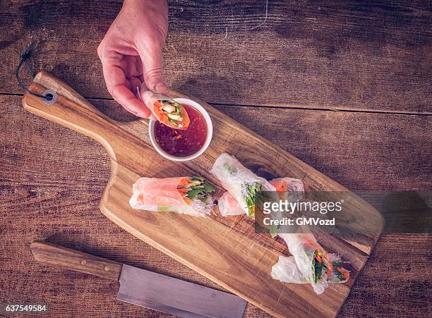 eating homemade spring rolls with fresh vegetables - rice paper stock pictures, royalty-free photos & images