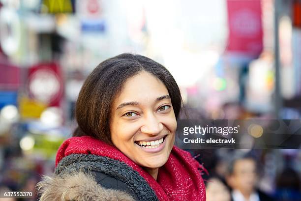 smiley young woman looking at camera - creole ethnicity 個照片及圖片檔