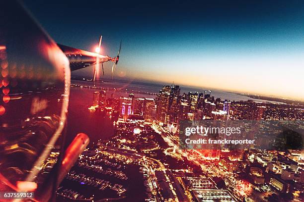 helicopter flying at dusk in miami - cockpit stock pictures, royalty-free photos & images