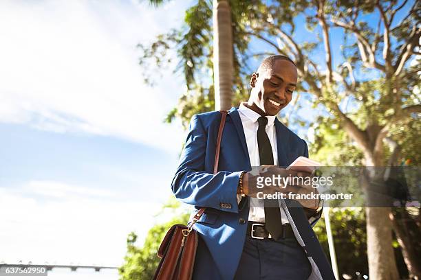 businessman texting in miami - african on phone stock pictures, royalty-free photos & images