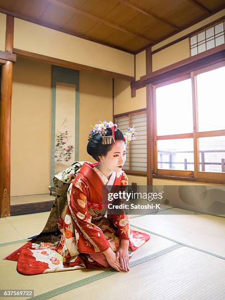 maiko girl sitting in tatami room for greetings - geisha in training stock pictures, royalty-free photos & images