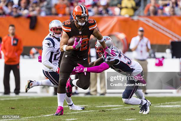 Tight end Gary Barnidge of the Cleveland Browns dodges free safety Devin McCourty of the New England Patriots during the second half at FirstEnergy...