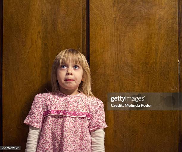 little girl looking awkward - shy fotografías e imágenes de stock