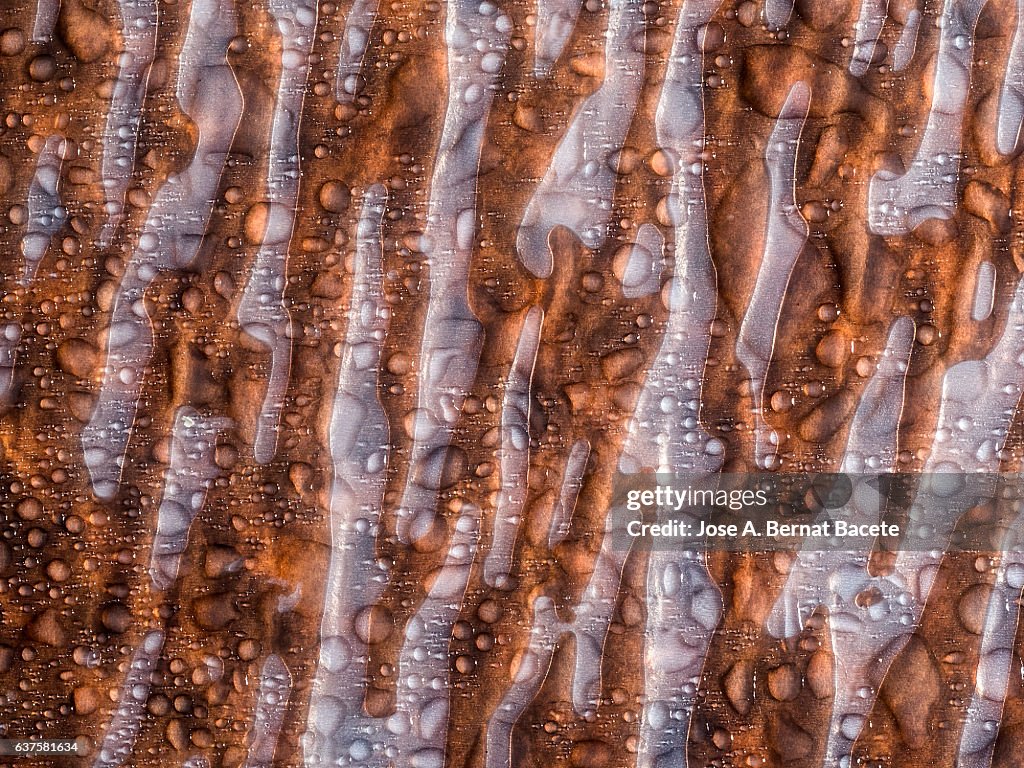 Full frame of the textures formed by the bubbles and drops,  on a coarse brown background