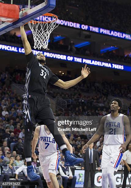 Karl-Anthony Towns of the Minnesota Timberwolves dunks the ball past Joel Embiid of the Philadelphia 76ers at the Wells Fargo Center on January 3,...