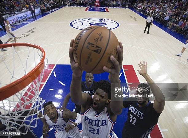 Joel Embiid of the Philadelphia 76ers attempts a layup against Karl-Anthony Towns of the Minnesota Timberwolves at the Wells Fargo Center on January...