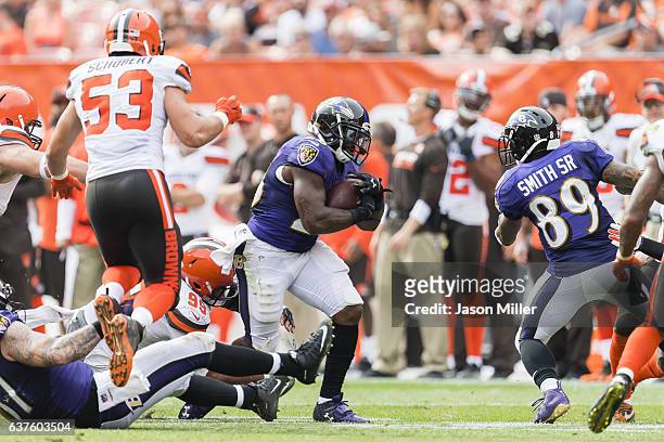 Running back Terrance West of the Baltimore Ravens runs for a first down during the second half against the Cleveland Browns at FirstEnergy Stadium...
