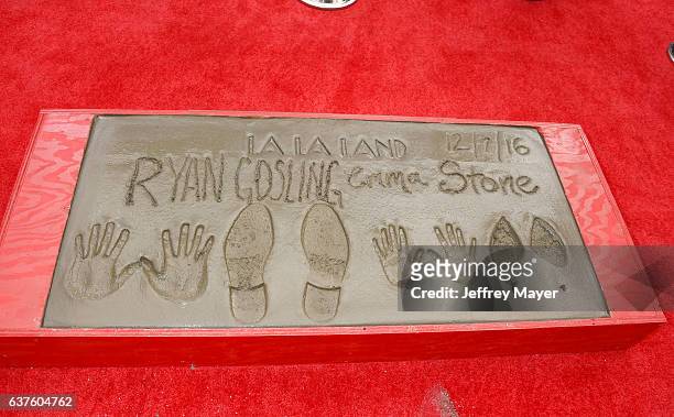 Actor Ryan Gosling and actress Emma Stone hands and feet in cement at the Hand And Footprint Ceremony for Ryan Gosling and Emma Stone at the TCL...