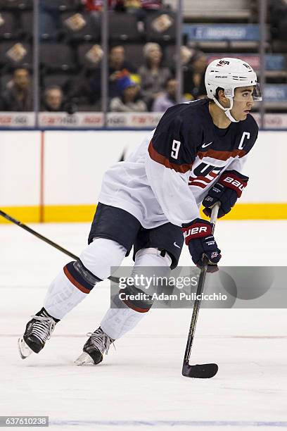 Captain forward Luke Kunin of Team United States skates through the neutral zone while looking to move the puck against Team Slovakia in a...