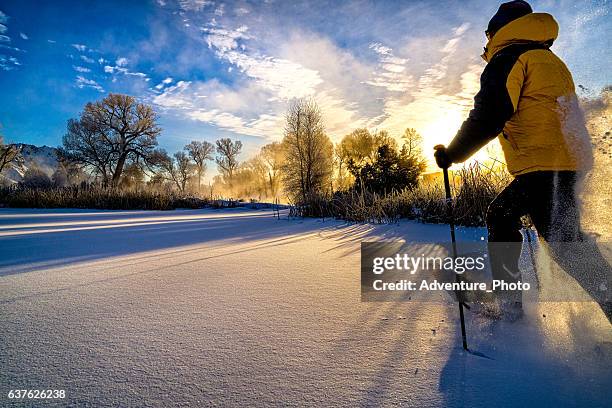 snowshoeing at sunset - snowshoeing colorado stock pictures, royalty-free photos & images