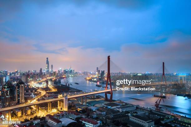 shanghai is divided into two parts by the huangpu river - city night stock illustrations