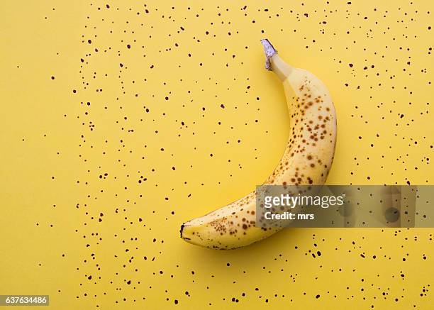 ripe banana with brown spots - ripe stock-fotos und bilder