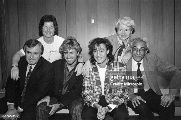 George Michael and Andrew Ridgeley of British pop group Wham! before they set off for their tour in China. Pictured with their parents, left to...