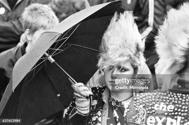 One of the CND protesters who marched through Coventry throwing the city centre into chaos. Seen here trying to keep dry and listen to one of the...