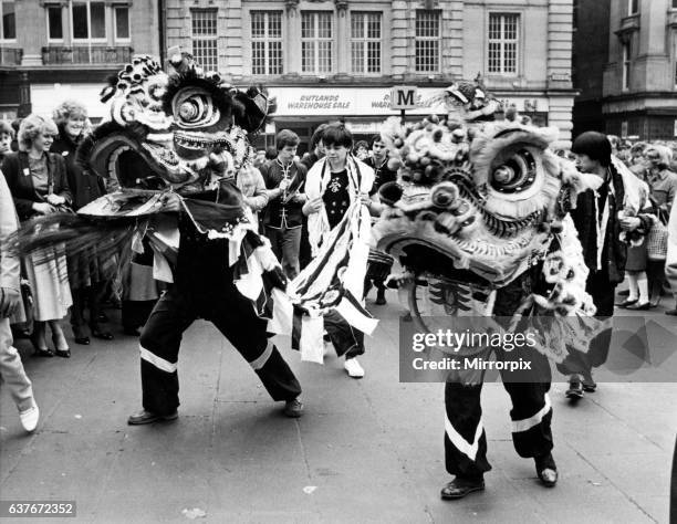 New Year Chinese style. A festive Dragon dance underway at Grey's Monument, Newcastle. 15th February 1983.