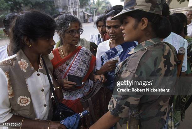 Sri Lankan Army soldier, right, checks IDs of Tamil civilians January 1,1998 in Jaffna City, Sri Lanka.