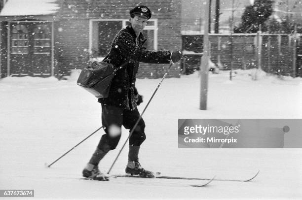 Postman on ski's in the snow, Reading, Berkshire. January 1982.