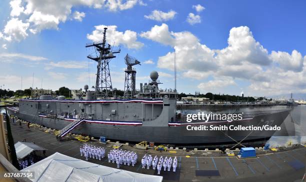 Sailors stand in formation in front of guided-missile frigate USS Crommelin during its decommissioning ceremony on Joint Base Pearl Harbor-Hickam,...