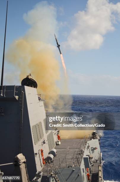 Guided-missile destroyer USS Michael Murphy fires its first missile while on the Pacific Ocean, 2013. Image courtesy Joshua A. Flanagan/US Navy. .