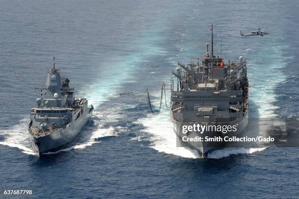 The German navy frigate FGS Hamburd and the Military Sealift Command fast combat support ship USNS Bridge during a replenishment-at-sea, Arabian Sea,...