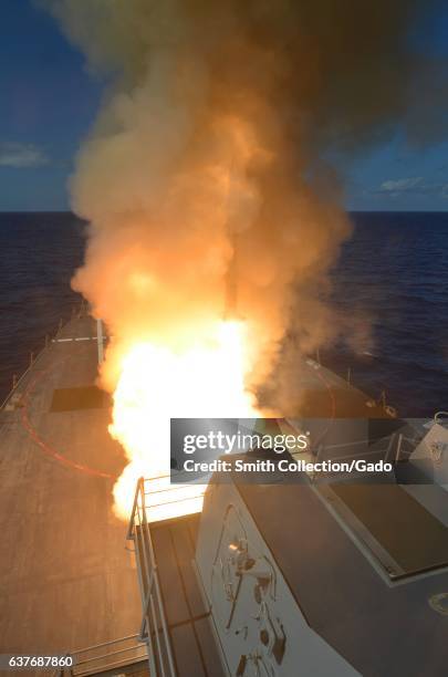 Guided-missile destroyer USS Michael Murphy fires a RIM-66M SM-2 missile, Pacific Ocean, 2013. Image courtesy US Navy. .