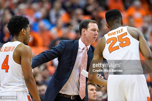 Assistant coach Gerry McNamara of the Syracuse Orange talks with Tyus Battle and John Gillon against the Miami Hurricanes during the first half at...