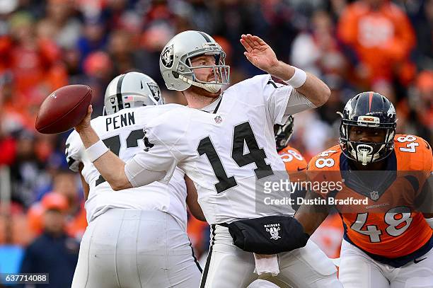 Quarterback Matt McGloin of the Oakland Raiders throws downfield in the first quarter of the game against the Denver Broncos at Sports Authority...
