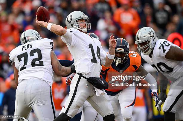 Quarterback Matt McGloin of the Oakland Raiders throws downfield in the first quarter of the game against the Denver Broncos at Sports Authority...