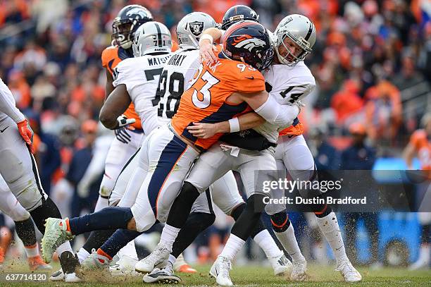 Defensive end Jared Crick of the Denver Broncos is called for a penalty while tackling quarterback Matt McGloin of the Oakland Raiders in the second...