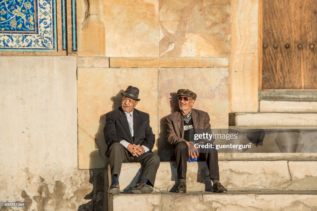 Dois homens sentados na frente de Mesquita Sheik Lotfollah, Isfahan