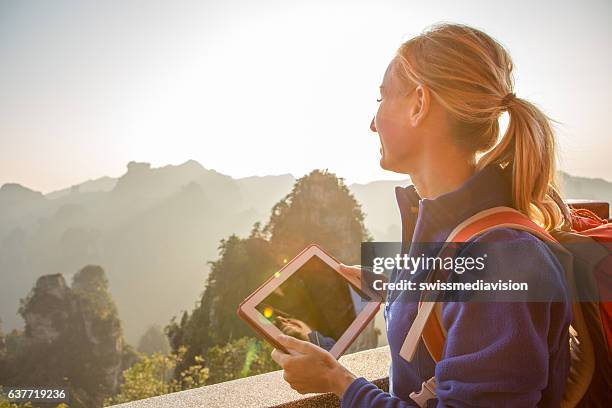 young woman hiker using digital tablet, mountain top - quartz sandstone stock pictures, royalty-free photos & images